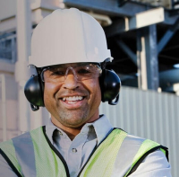Worker wearing a hard hat and hearing protection